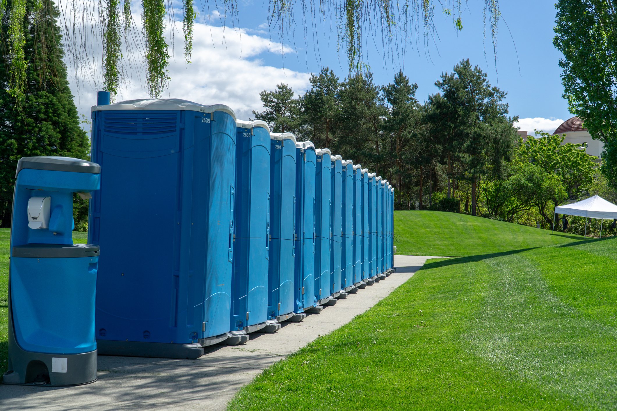 row of blue portable restrooms